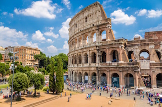 The Colosseum in Rome under a blue sky