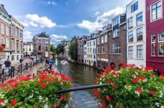 Amsterdam canal with colourful narrow houses and boats