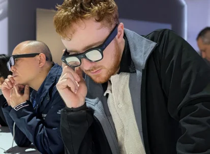 Visitors testing AI glasses at an industry event